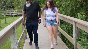 Nerdy Milf strokes and suck blk dick in the Park