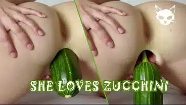 A woman shoves a huge zucchini into herself. Crazy food fetish.