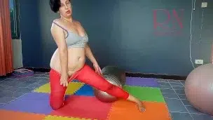 Regina Noir. A woman in yoga leotards practices yoga in the gym. Transparent red leotard yoga. 2