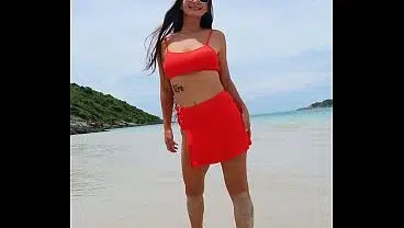Orange bikini fun and beauty flashing on the beach