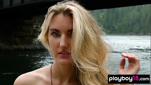Blonde naked Canadian musician Anna Katarina playing on her guitar outdoor